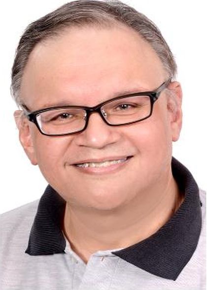 Portrait of Ian Poulier in a grey polo shirt