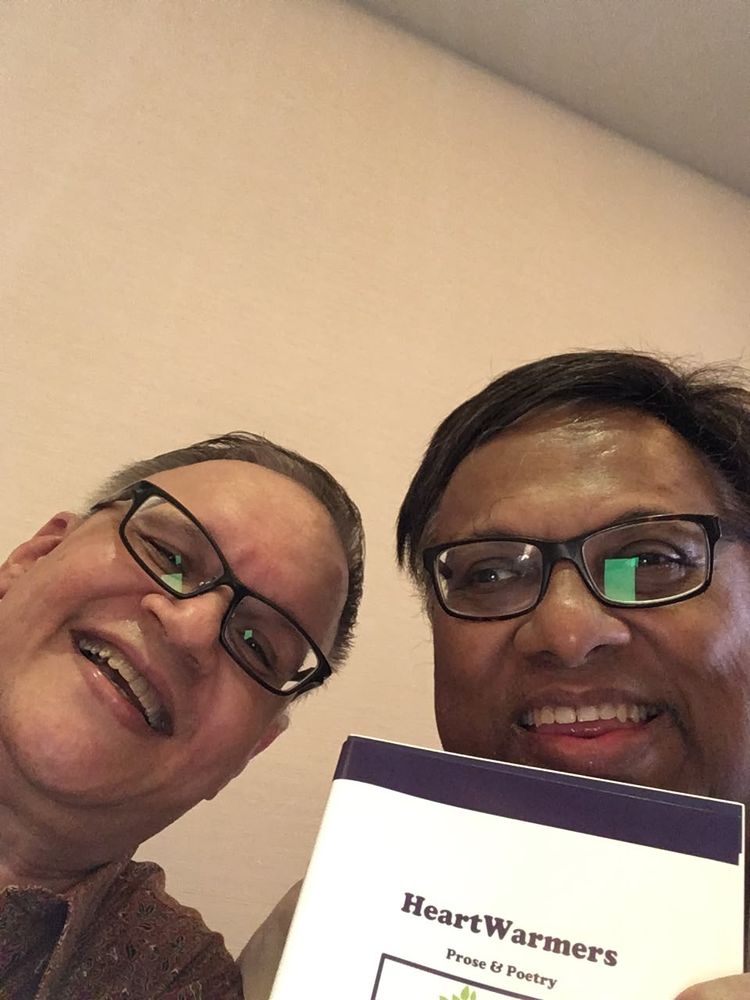 Ian and his co-author holding a copy of HeartWarmers