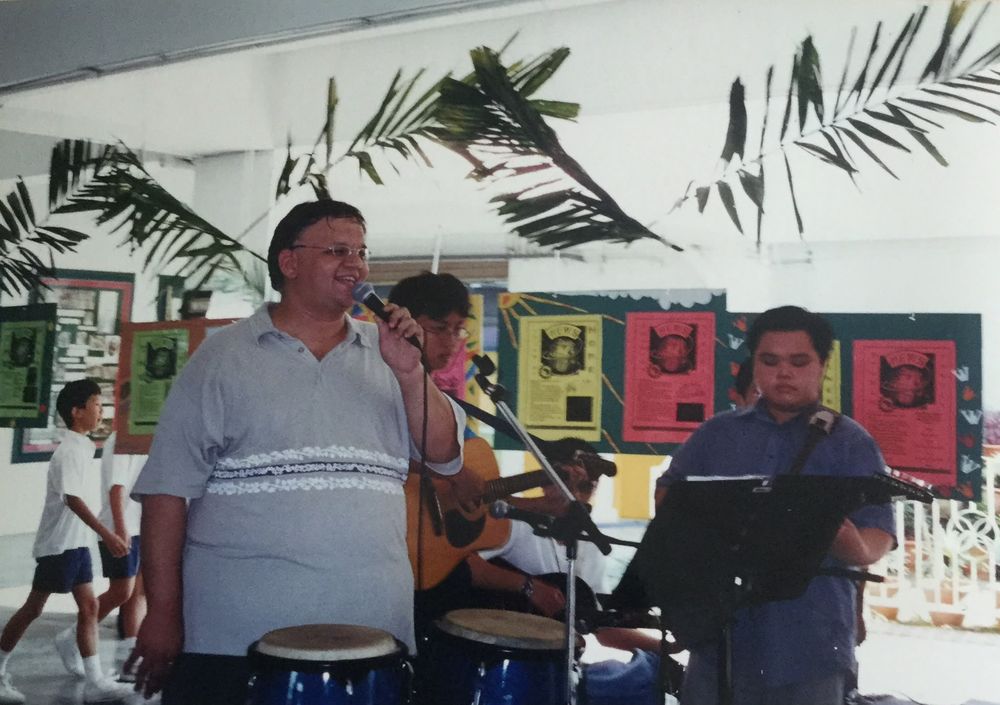 Ian singing with a student band at school