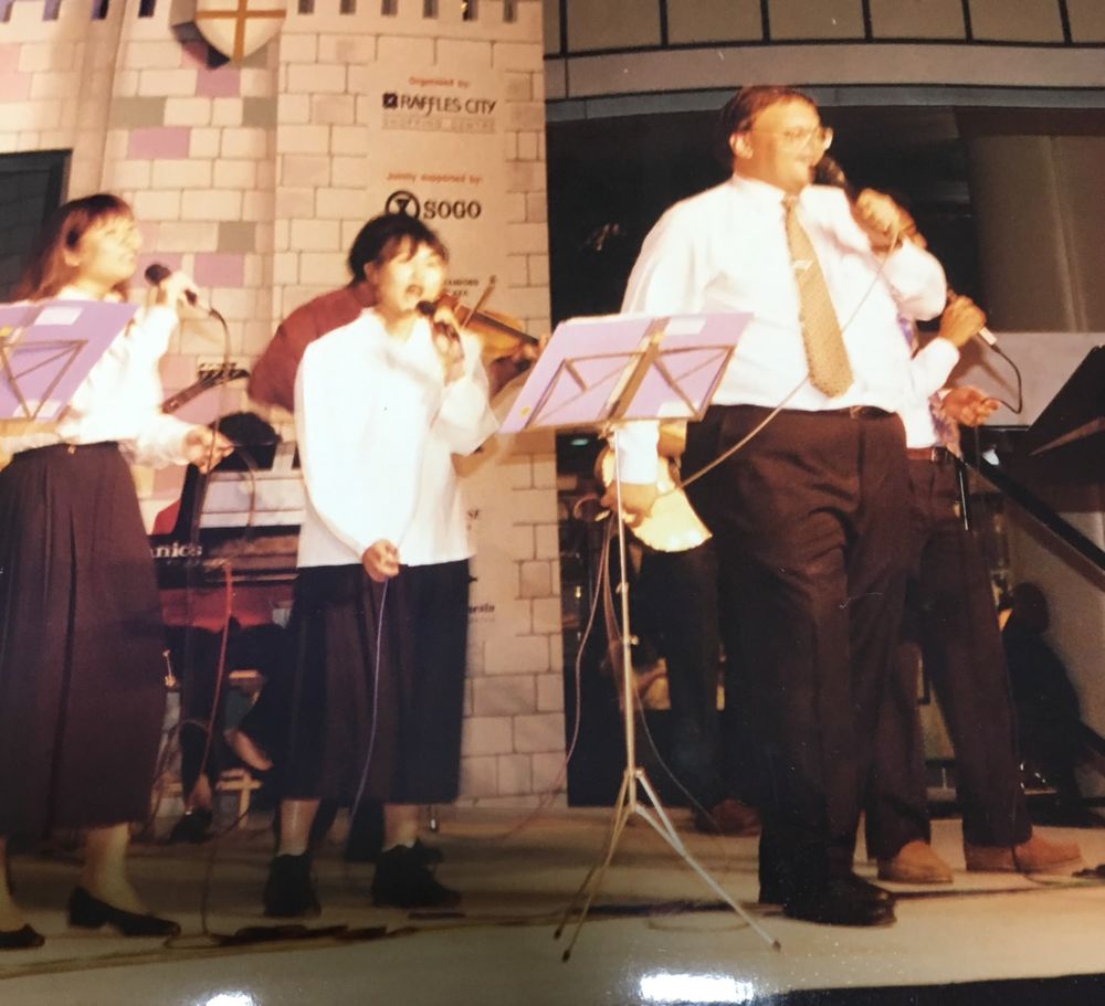 Ian singing on stage at Raffles City